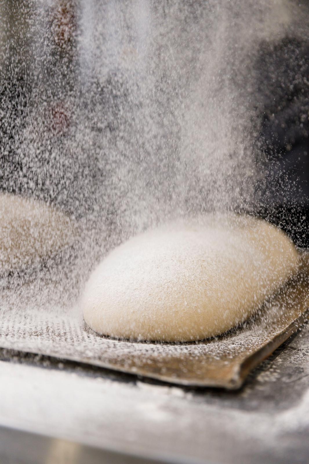 Flour dusting a proving loaf